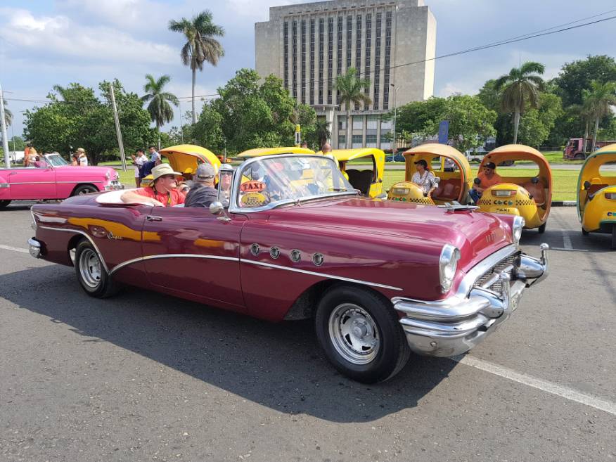Touring in an old vintage American car in Revolution Square, Havana